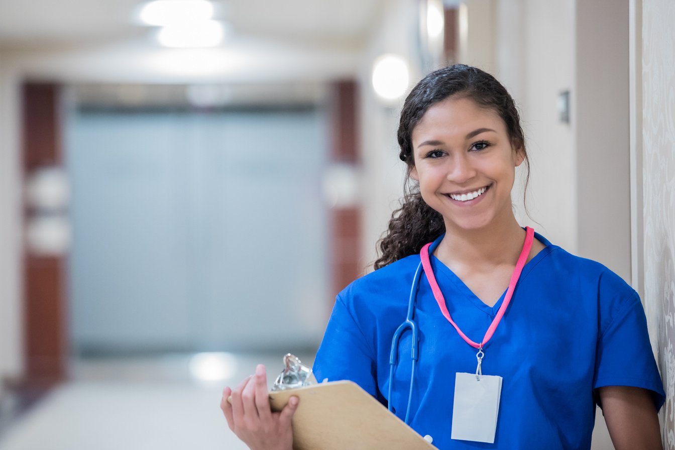 Young smiling nursing student holding clipboard